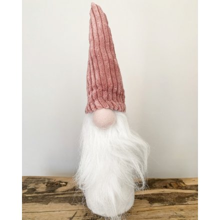 A standing gonk decoration complete with a round button nose, fuzzy white beard and high pointed corduroy hat 