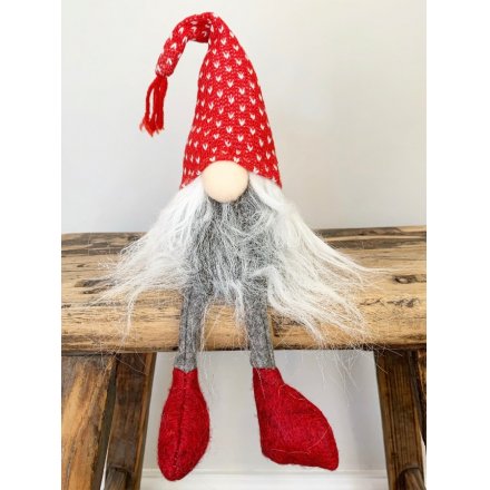 A dangly legged fabric gonk set with a long fuzzy grey beard, round button nose and high pointed knitted hat 