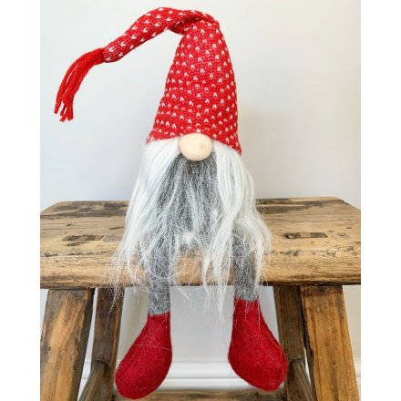 A dangly legged fabric gonk set with a long fuzzy grey beard, round button nose and high pointed knitted hat 