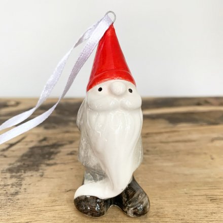  A nordic inspired ceramic gonk figure with a red pointed hat and grey body 