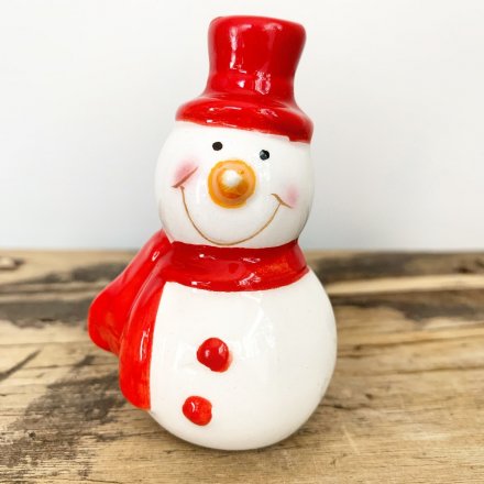 A cute mix of mini ceramic snowmen figures, dressed up in festive red toned hats and scarves