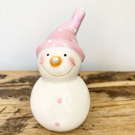 A cute mix of mini ceramic snowmen figures, dressed up in pretty pink toned hats and scarves