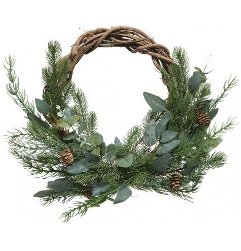 A rustic woven twig wreath wrapped with an abundance of artificial Christmas foliage and adorned with pinecones.