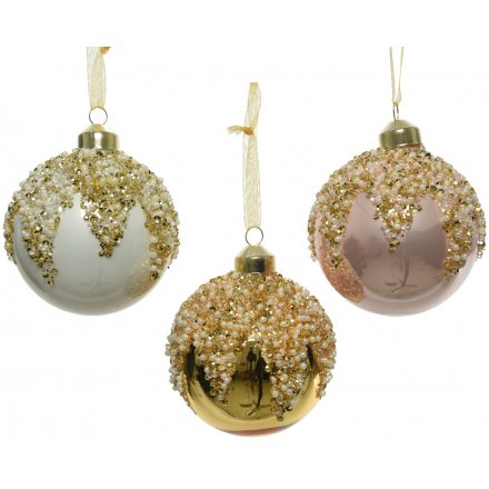 A mix of pink, gold and white glass baubles each with an ornate beaded top. 