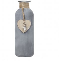  A simple yet stylish natural toned concrete bottle featuring a woven jute neck and hanging heart decal 