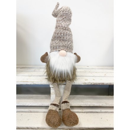 A sitting festive gonk in beige with a tall wooly hat