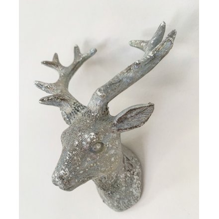 A decorative silver Stags head featuring a white washed tone and added sparkle effect