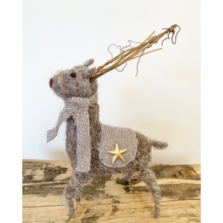 A gorgeous grey felt reindeer with a gold and grey knitted scarf and coat and twig antlers.