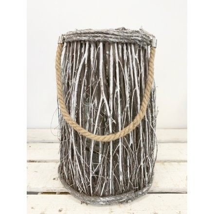 A snowy white washed lantern made from woodland twigs to give you a cosy feel on a cold winter night