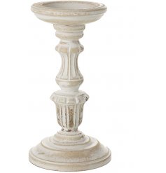 A stylishly chic standing wooden candle holder set with a distressed white washed finish 