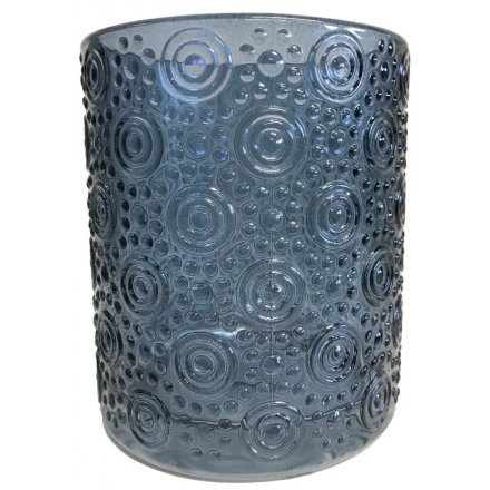  A small decorative glass pot featuring a embossed circle decal and neutral blue tone 