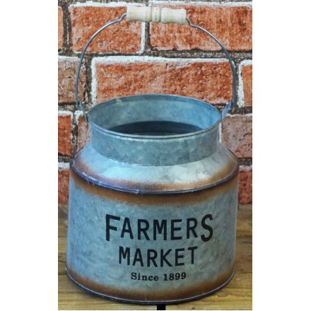   A decorative churn featuring a bold Farmers Market printed decal and added rusted edging 
