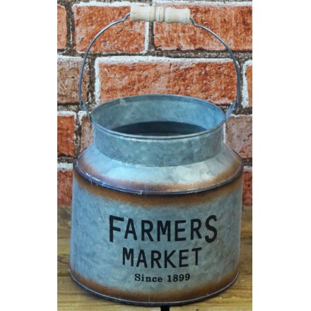   A decorative churn featuring a bold Farmers Market printed decal and added rusted edging  