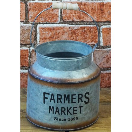 A small decorative churn featuring a bold Farmers Market printed decal and added rusted edging 