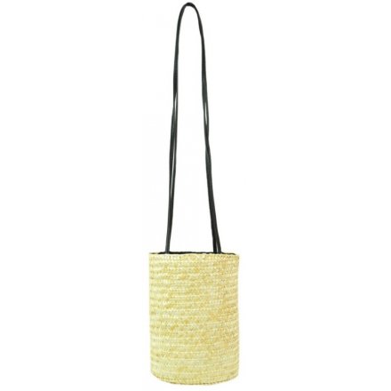 A long over the shoulder bag featuring a Raffia trim decal and round shape 