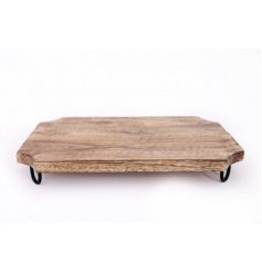 A natural wooden chopping board set on top of black wire legs 