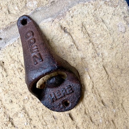 A cast iron beer bottle opener complete with a distressed decal 