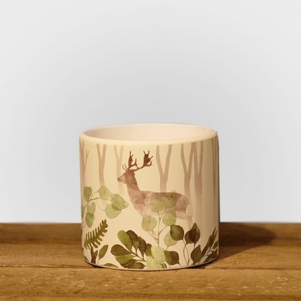 A stylish planter with a woodland design featuring colourful leaves and a stag.