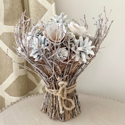A charming white and silver bouquet bound with rustic twigs and a jute string bow. 