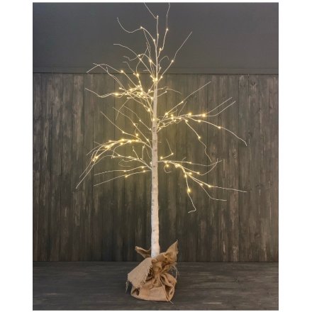  A birch bark inspired twig tree with warm glowing LED tips, perfectly placed within a hessian bagged base 