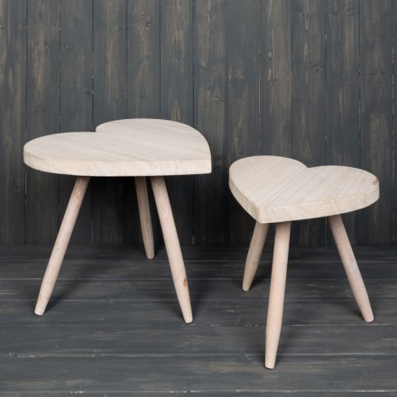  A small sized heart shaped stool complete with a smooth natural wooden feature.