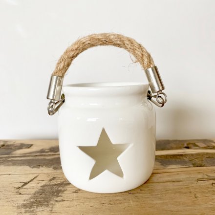 A chic white lantern with a star cut out feature and chunky rope carry handle.