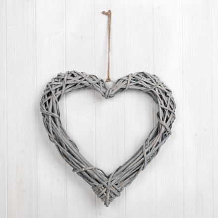 A large woven heart wreath made from natural rattan. Complete with a chunky rope hanger.