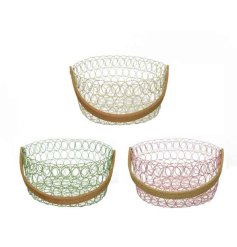 An assortment of 3 iron baskets in bright pink, green and yellow colours.