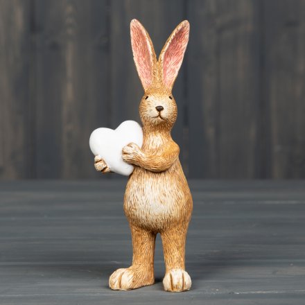Stood holding a little love heart, this cute resin bunny decoration will be sure to add a spring touch to any home! 