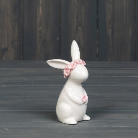 A charming rabbit ornament adorned with a pink floral crown. 