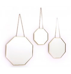 A set of 3 assorted sized hanging mirrors set in a geometric design 