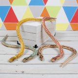 The Retro Games Wooden Snake is brightly painted with patterns that mimic natural scales