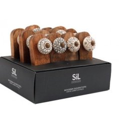  An assortment of natural wooden doorstop wedges complete with white ceramic knobs on top 