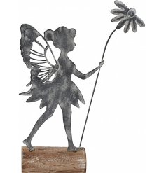 A rustic metal fairy decoration set upon a wooden base. 