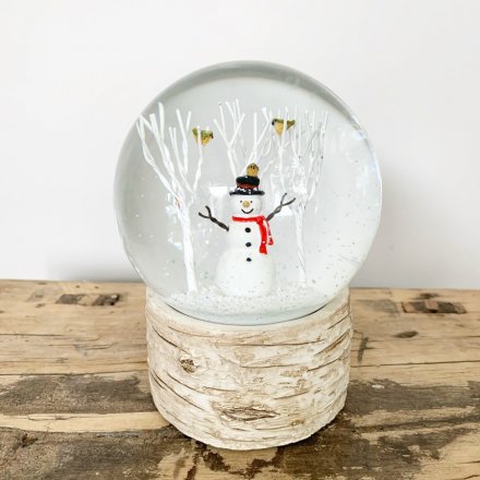 Set upon a woodland bark inspired base, this snowglobe features a happy little snowman in the centre 