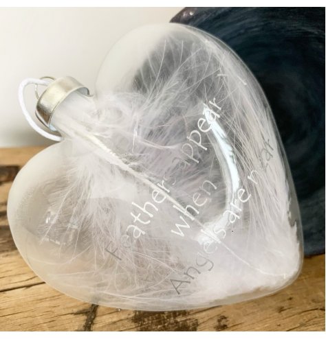 A chic, heart shaped glass decoration with silver text reading 'Feathers appear when angels are near'. 