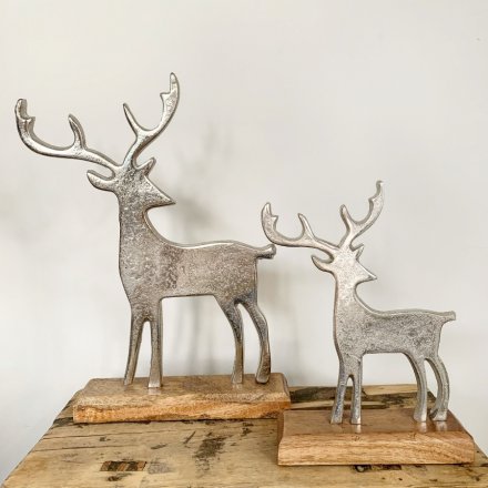  A beautifully simple ornamental reindeer set upon a natural wooden block 