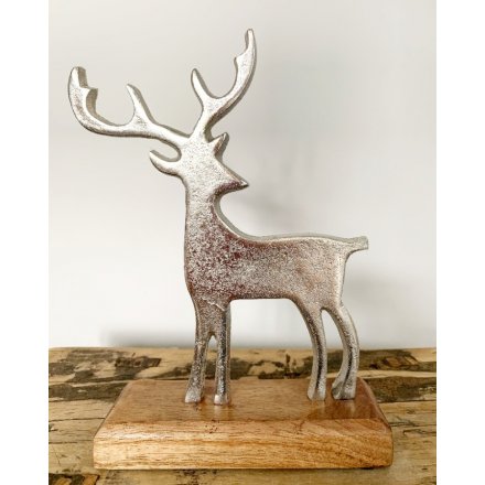   A beautifully simple ornamental reindeer set upon a natural wooden block 