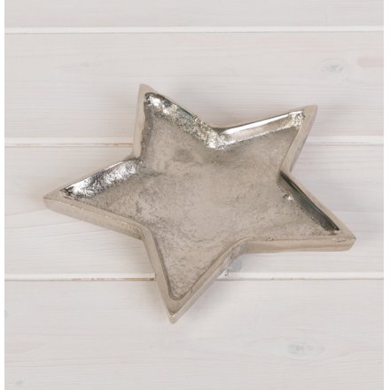 A chic silver metal star shaped dish with a hammered finish. A rough luxe interior accessory for the home.