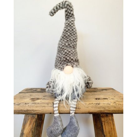 A super soft shelf sitting gonk decoration with a checked hat and mittens. Complete with faux fur beard.