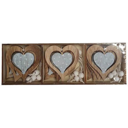 A cute little set of hanging wooden hearts each decorated with a blue and white polka dot decal 