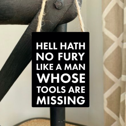 A humorous mini metal sign reading hell hath no fury like a man whose tools are missing.