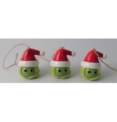 A ceramic brussel sprout hanging decoration set with a festive red hat