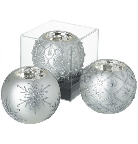 Highly decorated glass t-light holders with silver glitter designs including teardrops, snowflakes and flowers.