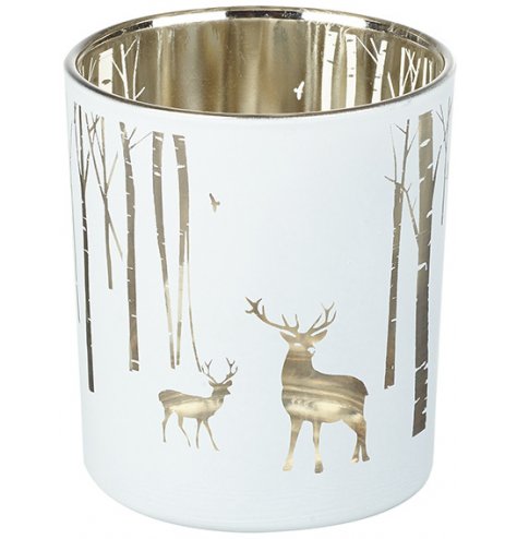 A silver lined glass tlight holder with an etched woodland decal across the front 