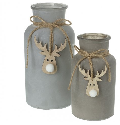 An assorted sized set of grey painted bottles decorated with wooden reindeer decals and tied string 