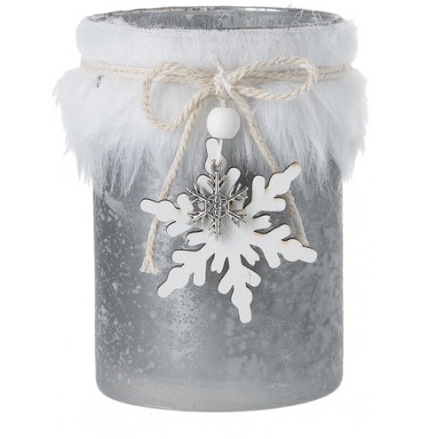 A decorative mottled glass candle holder wrapped in a white faux fur trimming and set with a wooden snowflake charm  