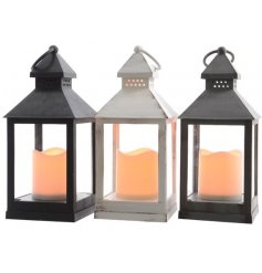 An assortment of 3 different coloured LED Lanterns with flickering candles in each 
