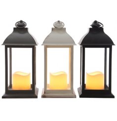 An assortment of 3 different coloured LED Lanterns with flickering candles in each 