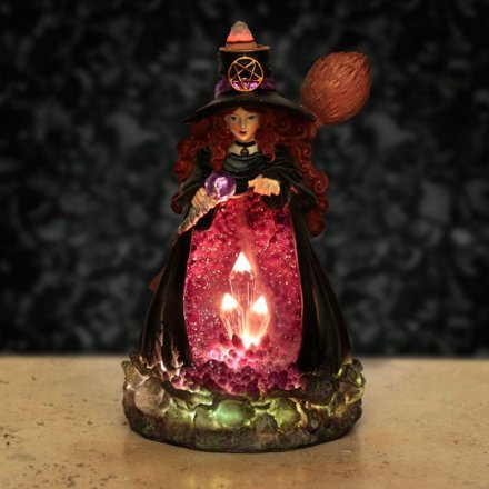A detailed witch with crystal filled cave lit with LED lights and backflow incense burner to release a mystical scent.